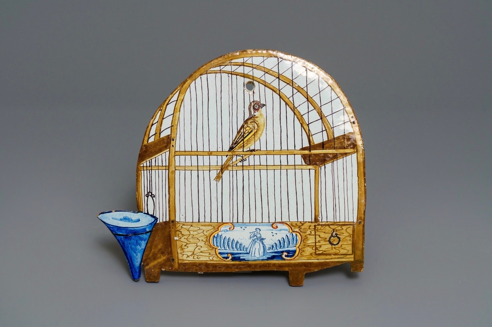 Une plaque en fa&iuml;ence polychrome de Delft &agrave; d&eacute;cor trompe l'oeil d'un cage &agrave; oiseaux, 18&egrave;me